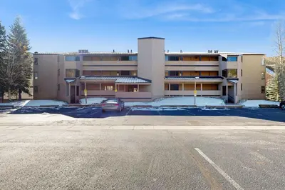 an empty parking lot in front of a building at Ski Run Condominiums 203 in Keystone