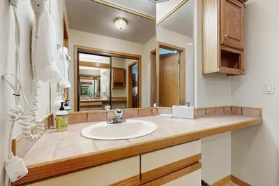 a bathroom with a sink and a mirror at Ski Run Condominiums 203 in Keystone