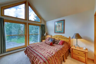 a bedroom with a bed and a large window at Snake River Village 05 in Keystone
