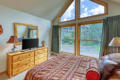 a bedroom with a bed and a large window at Snake River Village 05 in Keystone