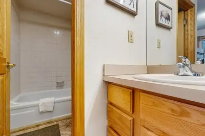 a bathroom with a sink and a bath tub at Snowdance Condo A101 in Keystone