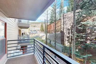 a balcony with a view of a building at Snowdance Manor 205 in Keystone