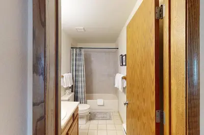 a bathroom with a tub and a toilet and a sink at Snowdance Manor 205 in Keystone