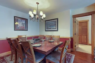 a dining room with a wooden table and chairs at Springs Lodge 8888 in Keystone