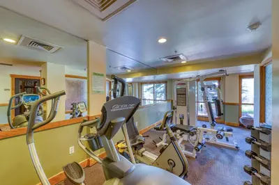 a gym with two treadmills and a treadmill at Springs Lodge 8888 in Keystone