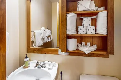 a bathroom with a sink and a mirror and towels at Springs Lodge 8906 in Keystone