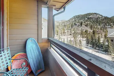 a blue surfboard sitting on a porch with a window at Springs Lodge 8906 in Keystone