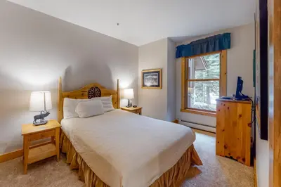 a bedroom with a large bed and a window at Trappers Crossing 8763 in Keystone