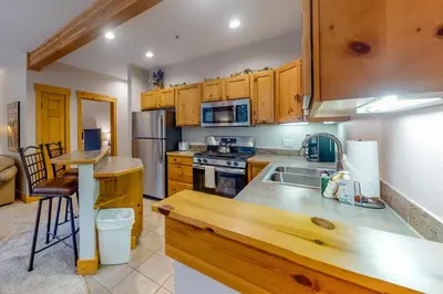 a kitchen with wooden cabinets and a counter top at Trappers Crossing 8763 in Keystone