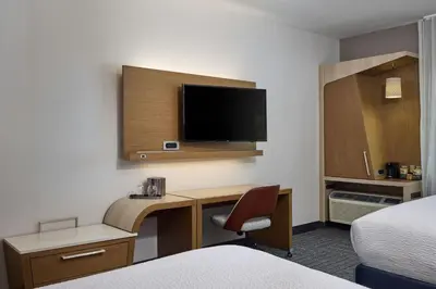 a hotel room with a desk and a tv at Courtyard by Marriott Denver Southwest/Littleton in Littleton