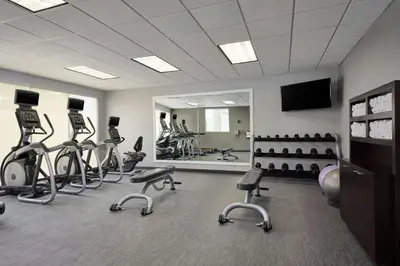 a gym with many exercise bikes and a mirror at Courtyard by Marriott Denver Southwest/Littleton in Littleton