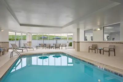 a swimming pool with chairs and a table and a tablektop at Courtyard by Marriott Denver Southwest/Littleton in Littleton