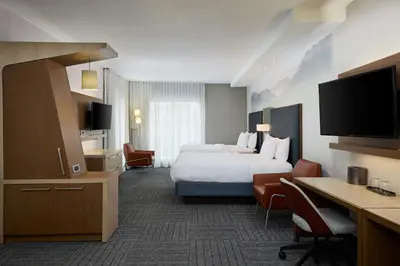 a hotel room with a bed and a desk at Courtyard by Marriott Denver Southwest/Littleton in Littleton