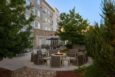 a patio with chairs and a fire pit in front of a building at Courtyard by Marriott Denver Southwest/Littleton in Littleton