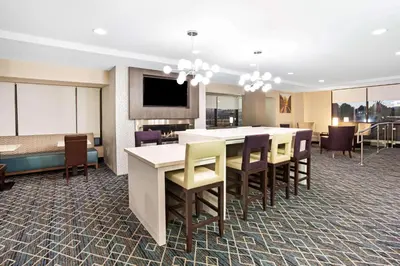 a conference room with a table and some chairs at La Quinta Inn & Suites by Wyndham Denver Aurora Medical in Aurora