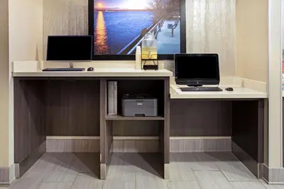 a desk with two monitors and a computer on it at La Quinta Inn & Suites by Wyndham Denver Aurora Medical in Aurora