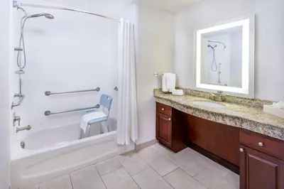 a bathroom with a tub and a sink and a shower at Homewood Suites by Hilton Denver - Littleton in Littleton