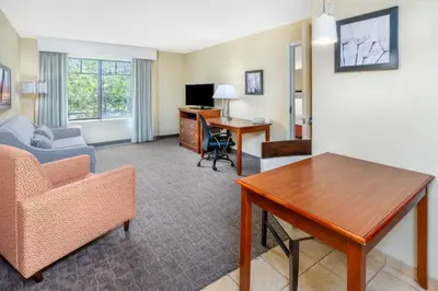 a living room with a table and a desk at Homewood Suites by Hilton Denver - Littleton in Littleton