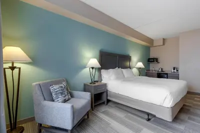 a hotel room with a bed and a chair at Comfort Inn & Suites Boulder in Boulder