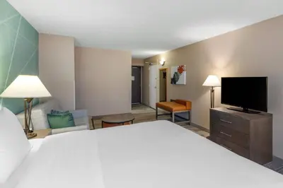 a hotel room with a bed and a flat screen tv at Comfort Inn & Suites Boulder in Boulder