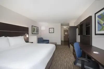 a hotel room with a large bed and a desk at Holiday Inn Express Hotel & Suites Longmont by IHG in Longmont
