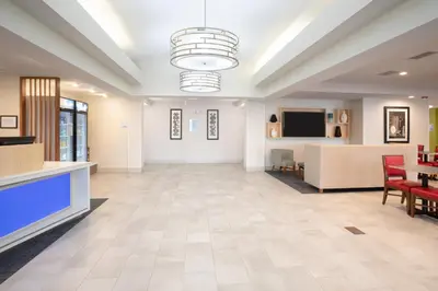 a lobby of a hospital with a table and chairs at Holiday Inn Express Hotel & Suites Longmont by IHG in Longmont