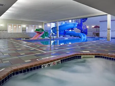 an indoor swimming pool with a water slide at Holiday Inn Express Hotel & Suites Longmont by IHG in Longmont