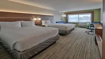 a hotel room with two beds and a desk at Holiday Inn Express & Suites Broomfield by IHG in Broomfield