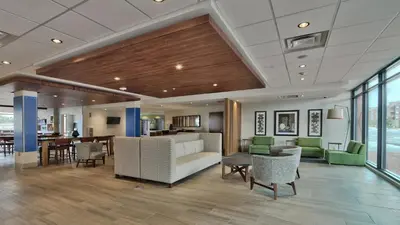 a lobby of a hotel with chairs and tables at Holiday Inn Express & Suites Broomfield by IHG in Broomfield