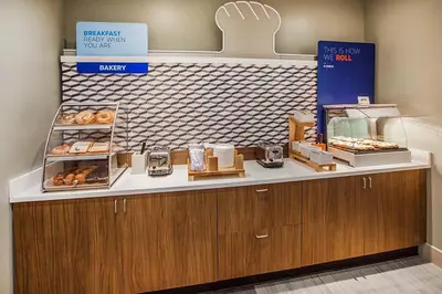 a bakery with a counter with donuts on it at Holiday Inn Express & Suites Broomfield by IHG in Broomfield