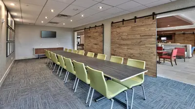 a conference room with a long table and chairs at Holiday Inn Express & Suites Broomfield by IHG in Broomfield