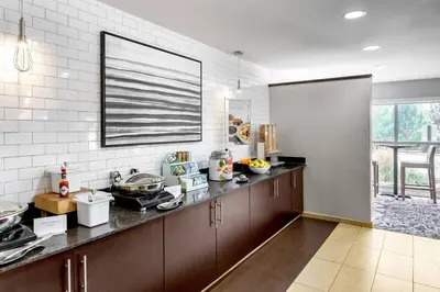 a kitchen with brown cabinets and a counter top at Residence Inn Denver North/Westminster in Westminster
