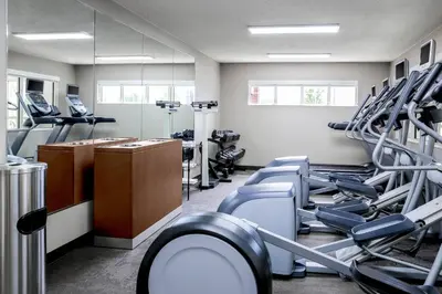 a gym with treadmills and machines in a room at Residence Inn Denver North/Westminster in Westminster
