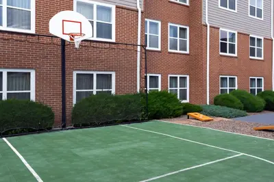 a basketball hoop attached to a brick building with a tennis court at Residence Inn Denver North/Westminster in Westminster