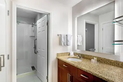 a bathroom with a sink and a shower and a mirror at Residence Inn Denver North/Westminster in Westminster