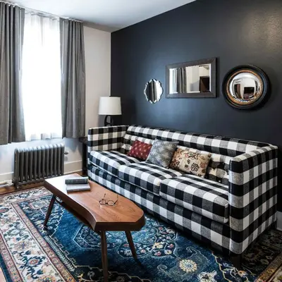 a living room with a couch and a table at The Armstrong Hotel in Fort Collins