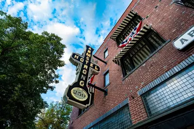 a clock on the side of a brick building at The Armstrong Hotel in Fort Collins