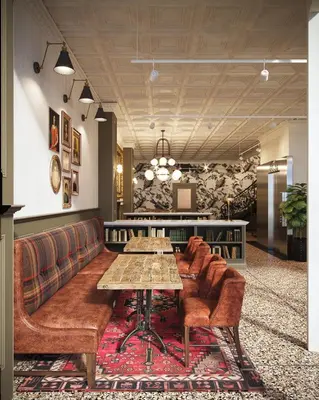 a restaurant with a table and chairs and a couch at The Armstrong Hotel in Fort Collins