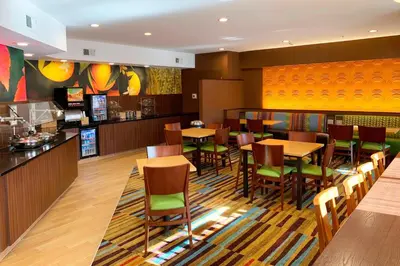 a restaurant with tables and chairs and a bar at Fairfield Inn by Marriott Denver / Westminster in Westminster