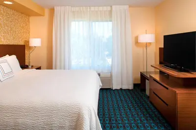 a hotel room with a bed and a flat screen tv at Fairfield Inn by Marriott Denver / Westminster in Westminster