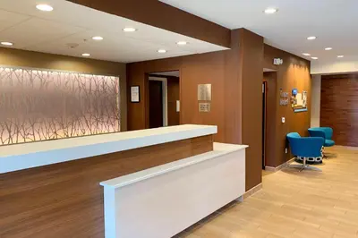 a hospital lobby with a reception counter and blue chairs at Fairfield Inn by Marriott Denver / Westminster in Westminster