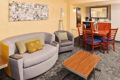 a living room with a couch and a table at Courtyard by Marriott Denver Cherry Creek in Denver