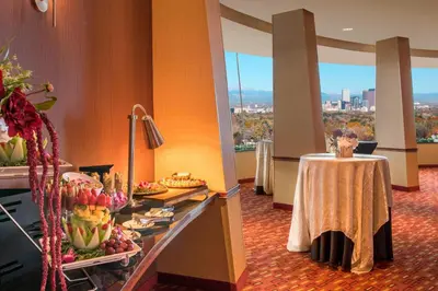 a buffet in a hotel room with a table with fruits at Courtyard by Marriott Denver Cherry Creek in Denver
