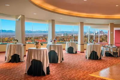 a room with four tables with flowers on them at Courtyard by Marriott Denver Cherry Creek in Denver