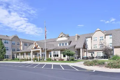 a building with an american flag in a parking lot at Residence Inn by Marriott Loveland Fort Collins in Loveland