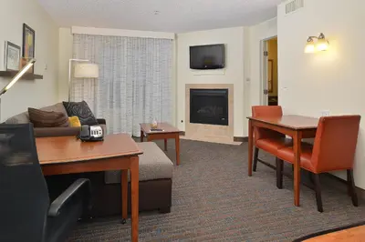 a living room with a couch and a fireplace at Residence Inn by Marriott Loveland Fort Collins in Loveland