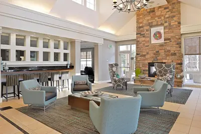 a living room with a couch and chairs and a fireplace at Residence Inn by Marriott Loveland Fort Collins in Loveland
