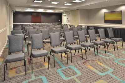 a conference room with chairs and a projection screen at Residence Inn by Marriott Loveland Fort Collins in Loveland