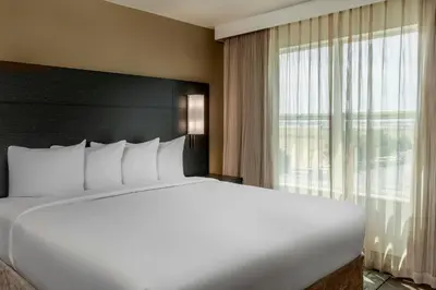 a large bed in a hotel room with a large window at Residence Inn by Marriott Denver Airport at Gateway Park in Aurora