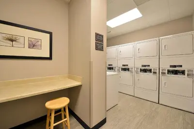 a waiting room with a stool and a row of refrigerators at Residence Inn by Marriott Denver Airport at Gateway Park in Aurora